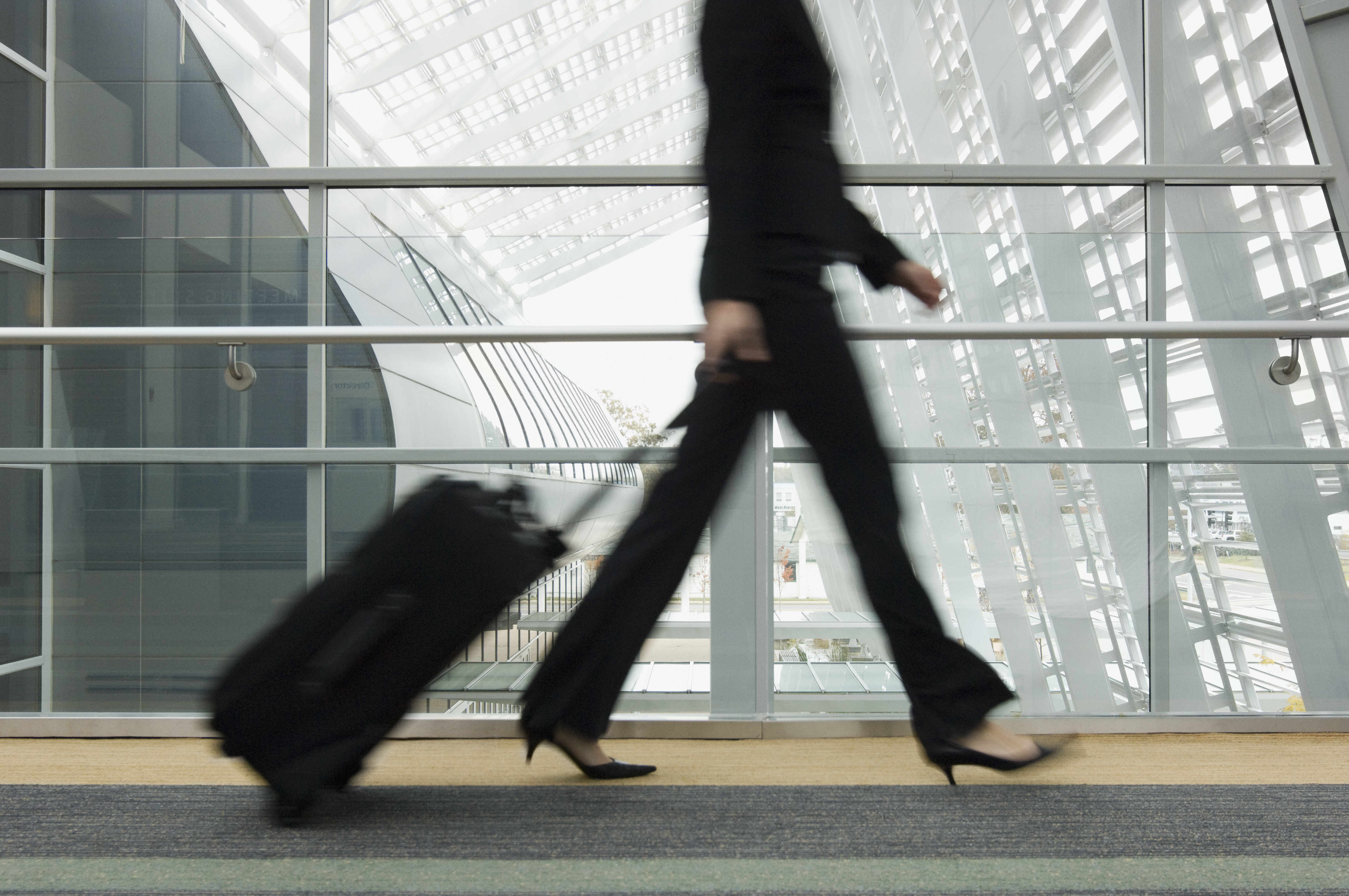 Businesswoman pulling suitcase